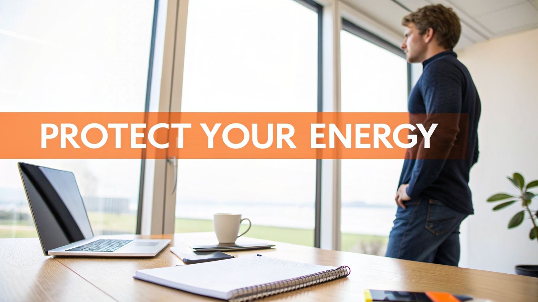 A man stands by a bright office window with a laptop on his desk, displaying 'PROTECT YOUR ENERGY' text.