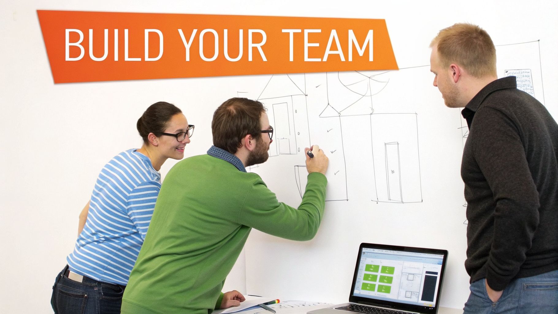 Three diverse team members collaborate on a whiteboard, sketching ideas and reviewing designs on a laptop.