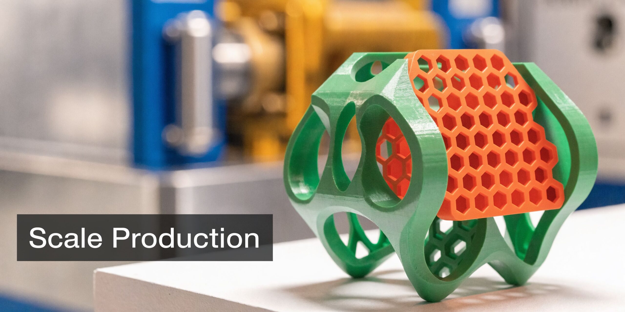 A 3D printed object with green organic structure and orange hexagonal infill sitting on a table.