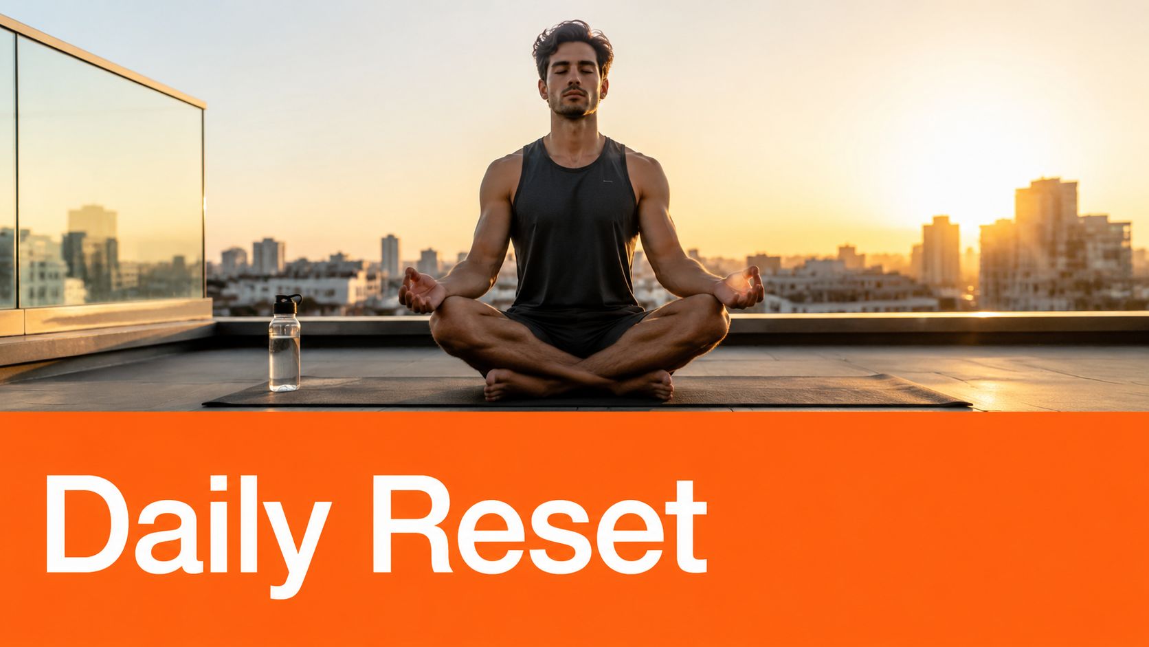 A fit man meditating in a lotus pose on a rooftop at sunrise with city skyline.