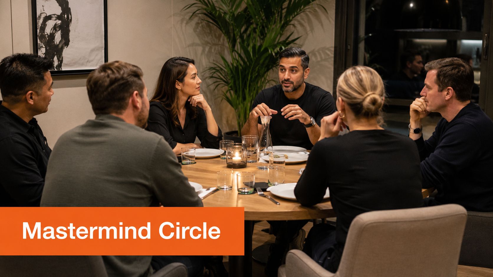 A diverse group of professionals sitting around a wooden table having a focused business mastermind discussion.
