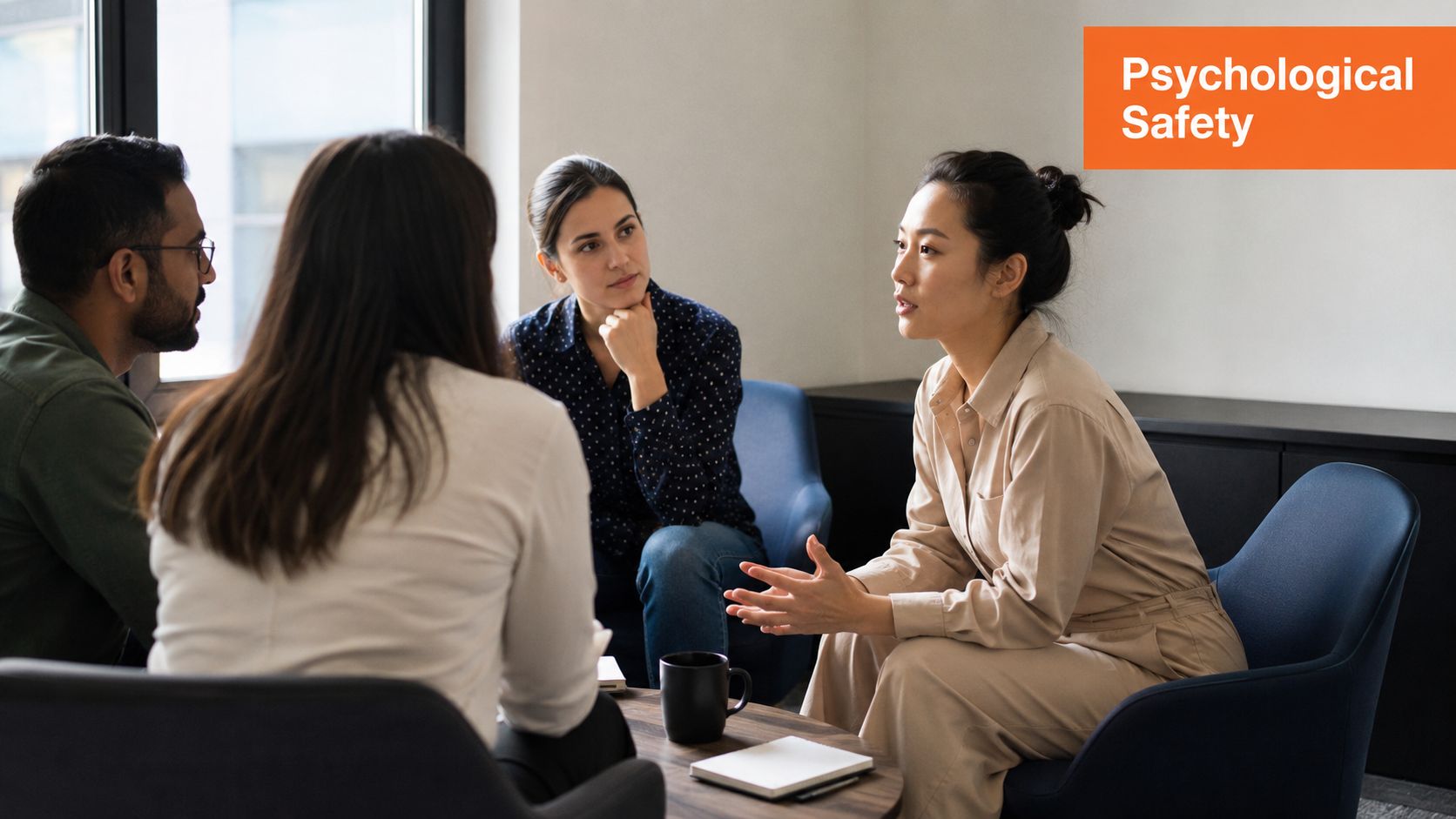 A diverse group of four professionals sitting in a circle having a thoughtful team discussion.